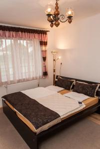 a bedroom with a large bed in front of a window at Annabella Apartman in Tiszafüred