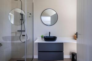 een badkamer met een wastafel en een spiegel bij Seagull View Sunset in Keurboomstrand +16 foto's