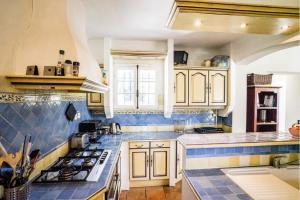 a kitchen with a blue and white counter top at Charming villa - perfectly located in Roquefort-les-Pins