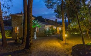 an exterior view of a house at night with trees at Charming villa - perfectly located in Roquefort-les-Pins
