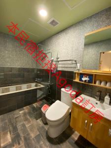 a bathroom with a toilet and a sink with red graffiti at Starry Night in Taitung City +22 photos