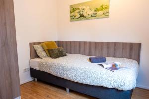 een slaapkamer met een bed met een houten hoofdeinde bij Short Stay Wageningen in Wageningen