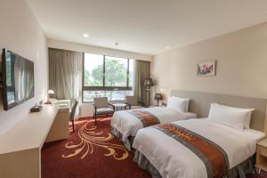 Postel nebo postele na pokoji v ubytování Royal Gold Hotel