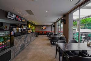 a restaurant with tables and chairs and a bar at Byon Hotel Şile in Şile