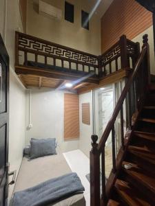 a bedroom with a loft bed and a staircase at Utama Lueng Bata Hotel in Luengbata