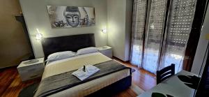 a hotel room with a bed and a table and a bed sidx sidx sidx sidx at HOTEL RISTORANTE DELLE VALLI in Germagnano