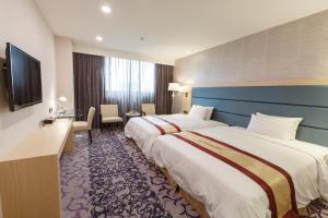 Postel nebo postele na pokoji v ubytování Royal Gold Hotel