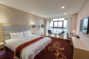 Postel nebo postele na pokoji v ubytování Royal Gold Hotel