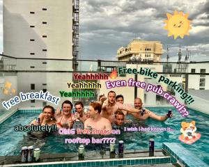 a group of people standing in a swimming pool at Bondi Backpackers Nhatrang in Nha Trang