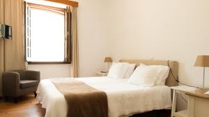 En eller flere senge i et værelse på Hospedaria Pielas