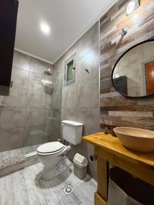 a bathroom with a toilet and a sink and a mirror at CABAÑAS MECHI in Mar del Plata +37 photos