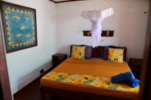a bedroom with two beds in a room at Hotel Les Boucaniers in Ambatoloaka