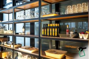 a shelf filled with lots of glasses and bottles at Hotiday Bologna Arena in Bologna