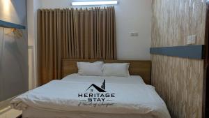 a bed with a residence stay sign on it at Heritage Stay Bagerhat in Bāgherhāt