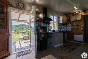 a kitchen with a sliding glass door leading to a patio at Le panier bio de noé in Noé