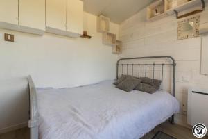 a bedroom with a bed in a small room at Le panier bio de noé in Noé