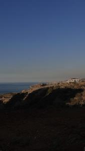 a view of the ocean from the top of a hill at Honey Chalet in Al Khayyām +2 photos