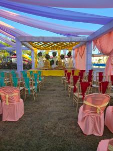 a group of chairs and tables under a tent at Shyam Resort in Khandwa