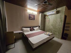 a small bedroom with a bed and a window at Shyam Resort in Khandwa +15 photos