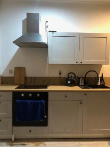 a kitchen with a stove and a blue towel at Apartament Cozy Studio in Żagań +6 photos