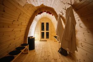 an archway in a room with chairs and a door at Aria Life Hotel Pinzolo in Pinzolo