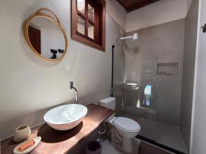 a bathroom with a sink and a toilet and a mirror at Casa Versace Salvador - Colonial House in Salvador +23 photos