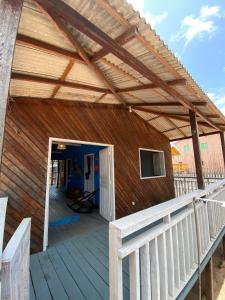 a wooden building with awning on a deck at Casa de Praia LUÁ in Bragança