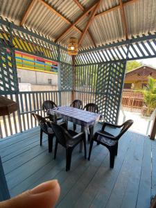 a table and chairs on a wooden deck at Casa de Praia LUÁ in Bragança