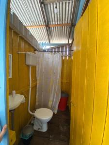 a small bathroom with a toilet and a sink at Casa de Praia LUÁ in Bragança +39 photos