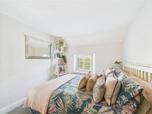 a bedroom with a bed with pillows on it at Smithy Stables in Barnard Castle