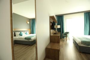 a bedroom with a mirror and a bed and a desk at Lina Garden Otel in Bingol