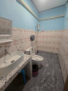 a bathroom with a sink and a toilet at Mook Lucky family in Ban Chao Mai +12 photos