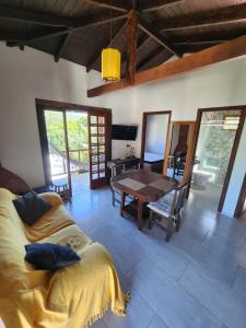 a living room with a couch and a table at Casablanca do Rosa in Praia do Rosa