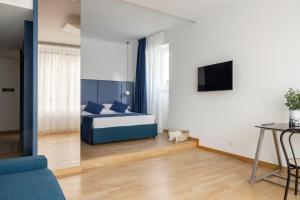 a bedroom with a bed and a television in it at Boutique Hotel Maria Vittoria in Rome