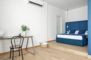 a bedroom with a bed and a desk with a chair at Boutique Hotel Maria Vittoria in Rome