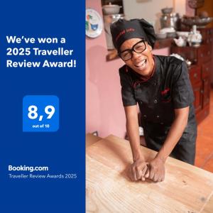 a man in glasses is leaning on a table at Hostal Mamà Mambò - Zona Colonial in Santo Domingo