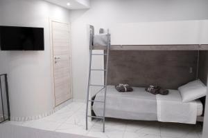 a bedroom with a bunk bed with a flat screen tv at B&B A Da Ziett Suite in Naples