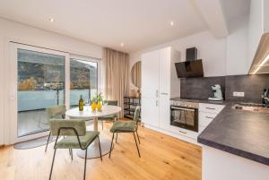 a kitchen and dining room with a table and chairs at Drei Berge Blick - by myNests in Gröbming
