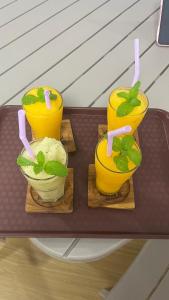 a tray with two glasses of orange juice and a sandwich at Kim house Koh Jum in Ban Ko Phrao +37 photos