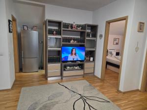 a living room with a flat screen tv in a entertainment center at Smiley Apartment in Sibiu