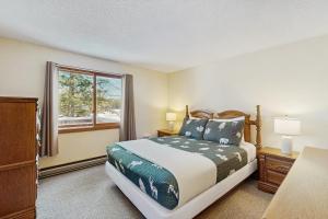 a bedroom with a bed and a window at Moose’in Around in Bridgton +44 photos