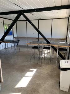 a group of tables and chairs in a tent at Dona Floripes Flats in Campinas