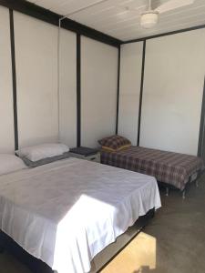 a bedroom with two beds in a room at Dona Floripes Flats in Campinas
