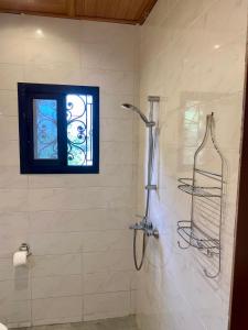 a shower in a bathroom with a window at Résidence Prestige KGV Appt 201 in Douala