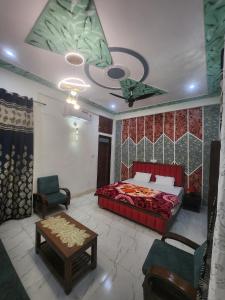 a bedroom with a bed and a table in a room at Dks villa Homestay in Agra +18 photos