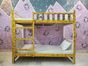 a bunk bed in front of a purple wall at Dks villa Homestay in Agra