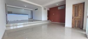 a empty room with a large window and a door at Villa Alicia Vavindrano in Fort Dauphin