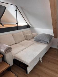 a couch in a room with a tent at Style Loft mit Ausblick in Elzach in Elzach