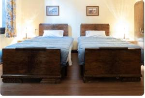 two beds in a room with two twin beds at Palacio de la Monstrua in Avilés +5 photos
