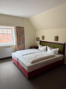 Postel nebo postele na pokoji v ubytování Hotel Krohwinkel